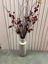 Red floral decor in tall floor vase in Houston, Texas