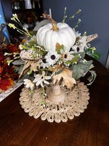 white pumpkin on a candle stick with fall leaves and white sunflowers in Fort Knox, Kentucky
