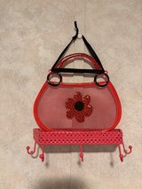 red decorative shelf with hooks. paid $10.00 in Alamogordo, New Mexico