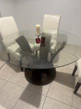 Glass top table with wooden base in Kissimmee, Florida