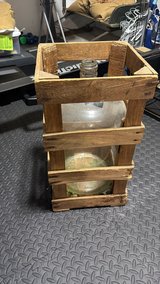 Wooden crate with glass jug in Byron, Georgia
