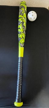 Kids bat with ball in Alamogordo, New Mexico