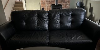 Black leather couch in Fort Lewis, Washington