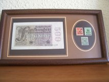 Historical 100+ year old German Reichbanknote for 500 Million Marks and three German stamps in Ramstein, Germany