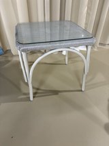 Glass and metal rattan table in New Lenox, Illinois