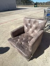 Brown faux leather armchair in Houston, Texas
