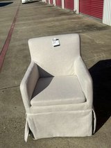 Light gray upholstered armchair in Kingwood, Texas