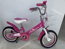 Pink bicycle with training wheels. in Okinawa, Japan