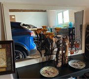 Framed prints, wooden cats and white mirror in Ramstein, Germany